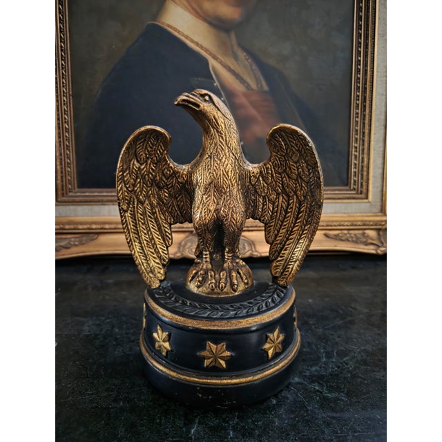 This striking pair of eagle bookends brings instant gravitas to a shelf, desk, or console. Finished in warm antiqued gold...