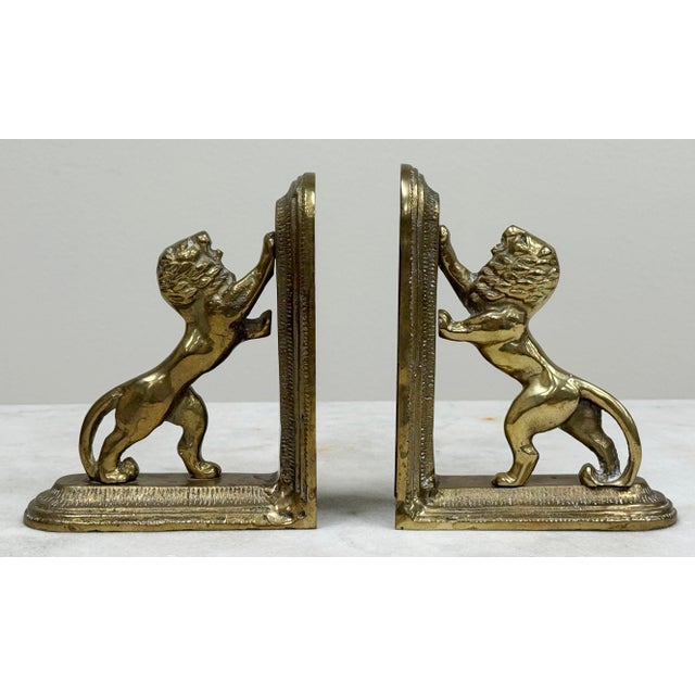 Regal vintage brass lion bookends in arched position on beveled brackets. Can be positioned with the lions facing up, or...