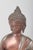 Large bronze Buddha figure. Large seated Buddha figure executed in patinated bronze with a serene facial expression,...