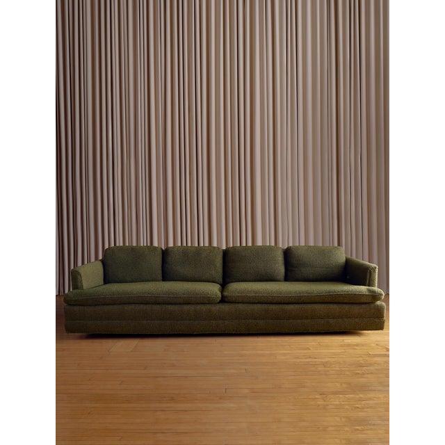 This vintage mid-century sofa in the style of Edward Wormley features a clean, low-profile silhouette with original...