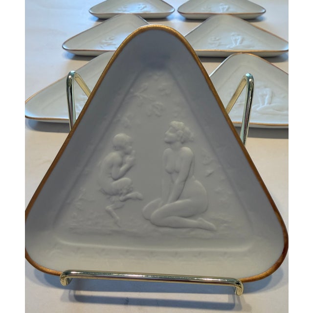 Purchased in Italy, this rare Set of 8 Les Griffes Collection D'Art" triangle bisque plates are styled after Joe Decomps...
