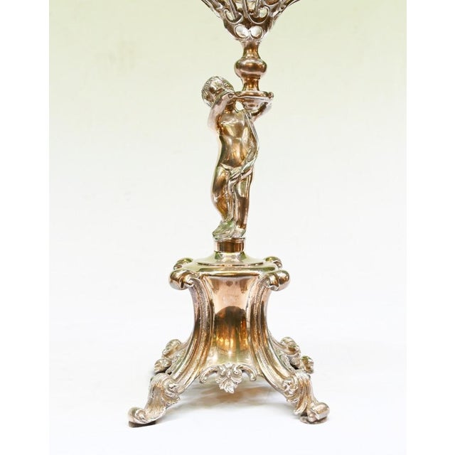 Stylish pair of silver plate cherubs holding aloft the frosted glass bowls Technically I suppose these are comports,...