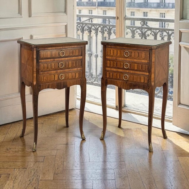 An elegant pair of French Marble Top Marquetry Side Tables ~ Nightstands, each fitted with three drawers and raised on...