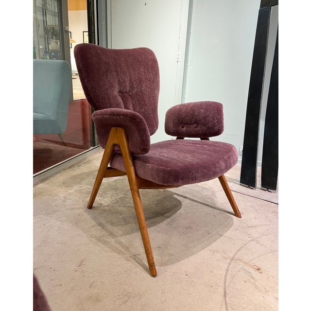 Pair of wooden and fabric lounge chairs by Roger Landault, France, circa 1950. Completely reupholstered in plum-colored...