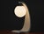 A mid century modern white Serpentine table lamp designed by Jack Hayward for Modeline of California. Glass globe in tact....