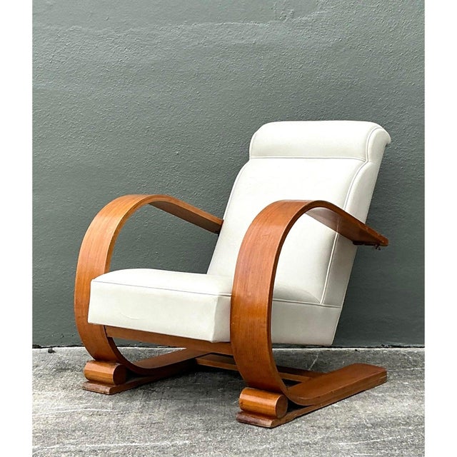This vintage 1940s plank armchair, inspired by Andoux and Minet, captures mid-century sophistication with its clean lines...