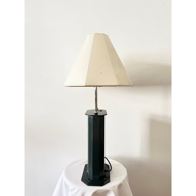 Vintage postmodern table lamp in metal with elegant chrome inserts, featuring a unique 4-light design. Two bulbs are...