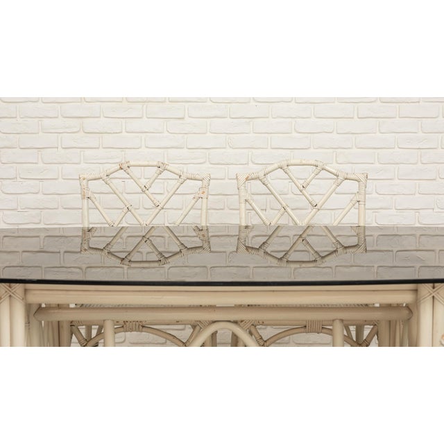 Garden dining set consisting of a rectangular bamboo table with a smoked glass top and six matching armchairs. The design...