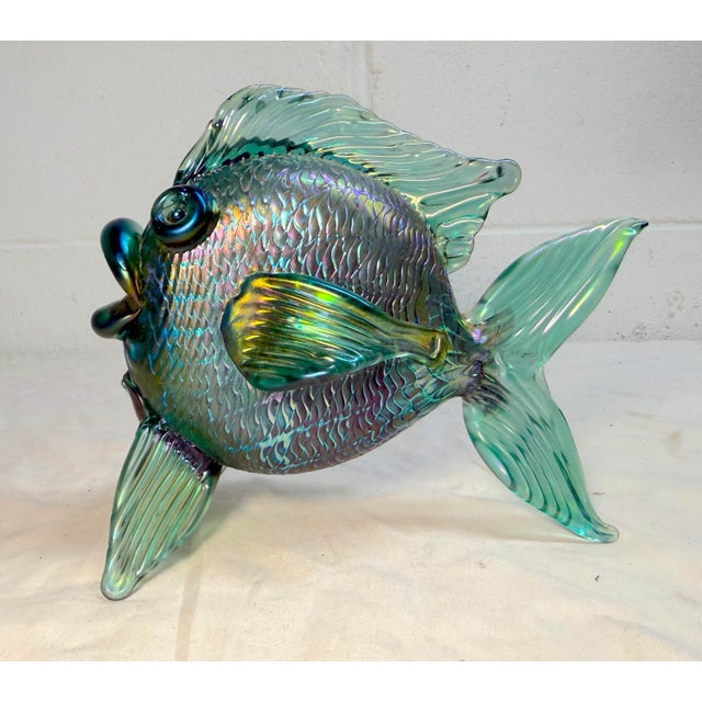 This vintage hand-blown glass fish sculpture by David Tate depicts a vibrant iridescent green and gold fish, showcasing a...