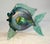 This vintage hand-blown glass fish sculpture by David Tate depicts a vibrant iridescent green and gold fish, showcasing a...