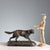 Bronze sculpture on a black marble base depicting a pointing hunting dog. The artist's signature is engraved on the base....