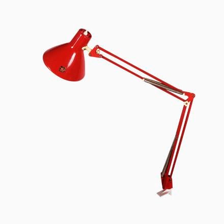 This lamp that is attached to the side of a desk was produced by Luxo in the 1970s. It is made from red lacquered steel...