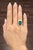 An exquisite 8.59-carat emerald-cut emerald ring, surrounded by a halo of 48 round white diamonds, radiates elegance and...