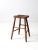 Here is an antique wooden stool. The rustic primitive stool features a saddle seat with splay legs.