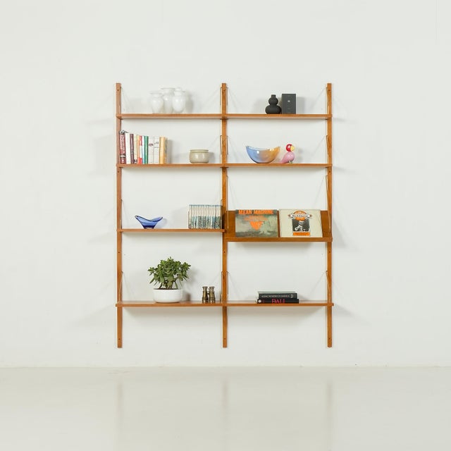 This Scandinavian vintage oak wall unit was made in Denmark some time in the 1970s. The same period as the famous Poul...