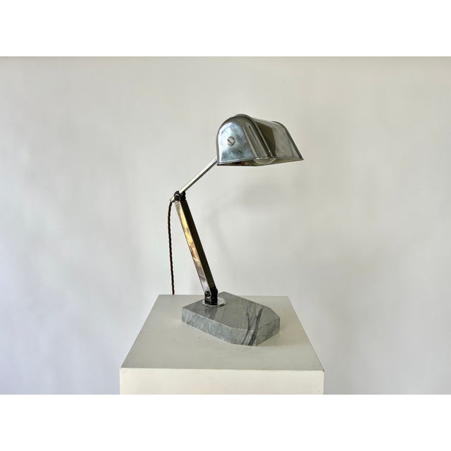 Art Deco Modernist table lamp, France, c.1920-30 Stainless steel arms with a heavy marble base. Adjusts and holds all...