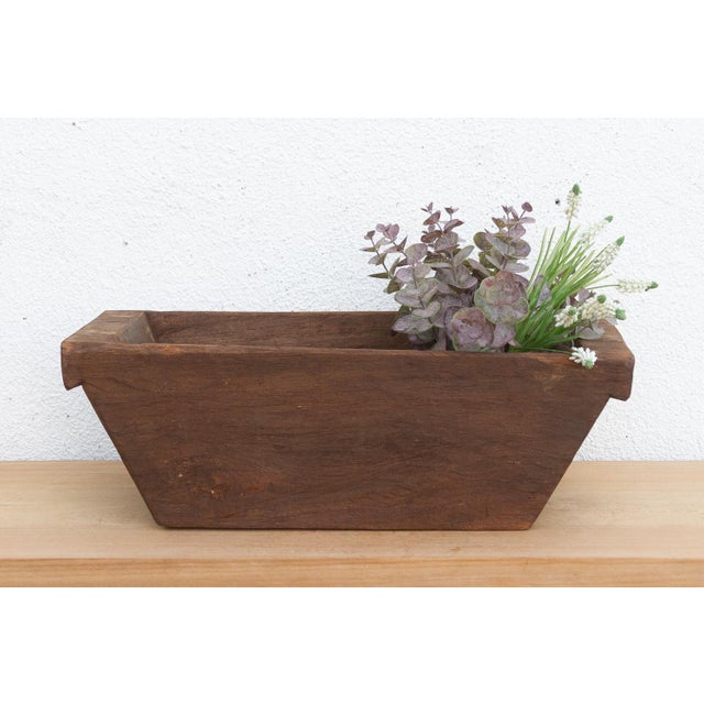 Carved from a single, massive log of hardwood, this antique wooden trough was likely originally used in a village setting...