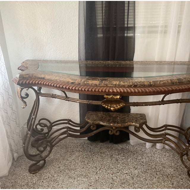 This is a beautiful Hollywood Regency / Mediterranean-style marble-top console table. It features an ornate wrought iron...