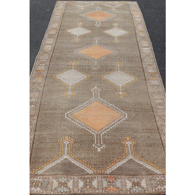 Measures: 5'2 x 13'6 Vintage Turkish Kars Gallery Runner with Soft Taupe, Sand, and Muted Orange. Keivan Woven Arts /...