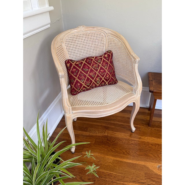 Rectangular lumbar throw pillow in a burgundy woven tapestry fabric. A gold trellis lattice frames small flowers in rose,...