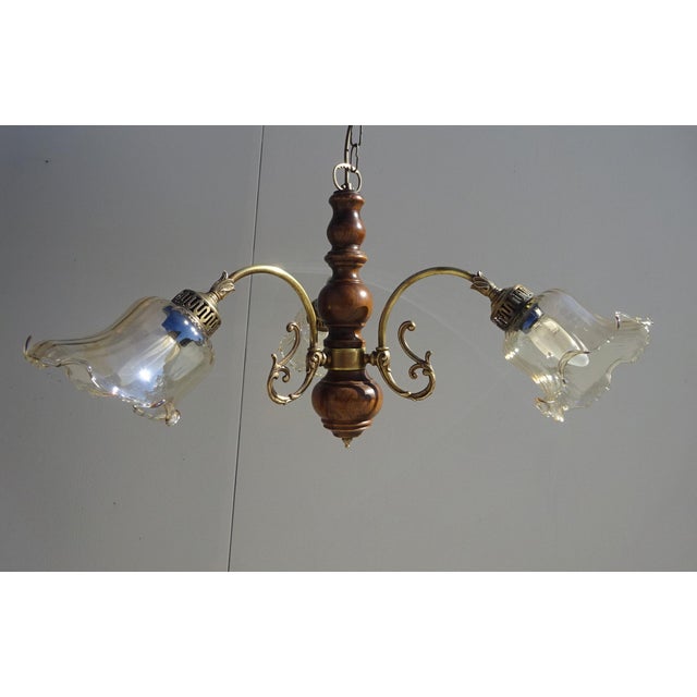 Three-light chandelier with three brass arms on a gilt bronze base, featuring floral motifs. Shades are made of lightly...