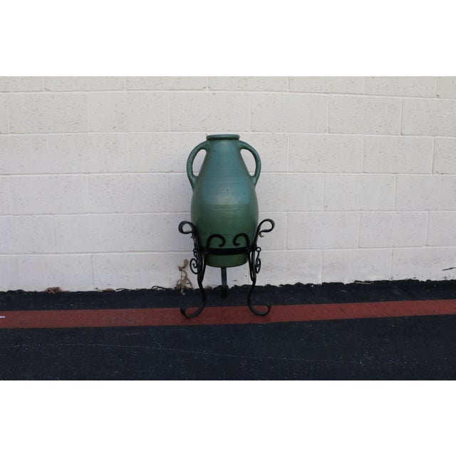 A beautiful and authentic 1920s olive green oil jar, showcasing timeless Mediterranean character and sculptural presence....