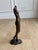 An elegant bronze female figure by American sculptor Tom Corbin (b. 1954), signed and numbered 36/40. The sculpture pairs...