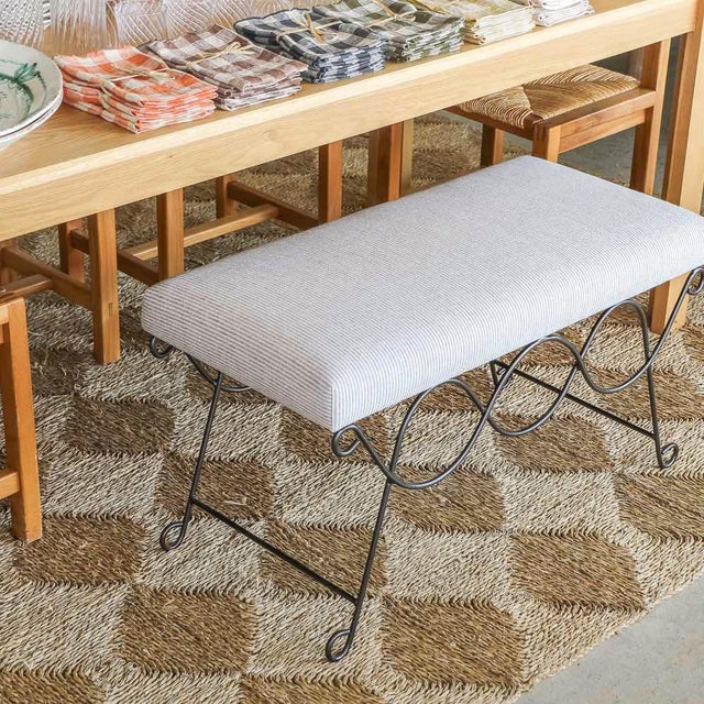 Beautiful iron bench with curved and looped base painted in a matte black finish inspired by French design. Rectangular...