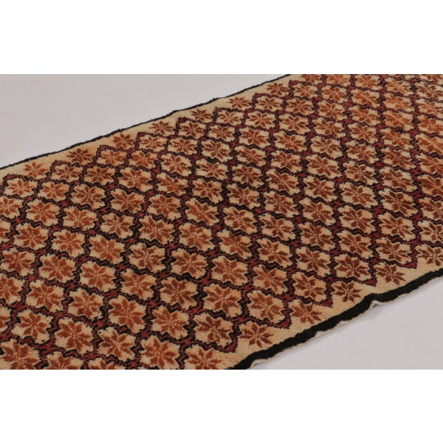 Made with hand-knotted high-pile wool in Turkey, this 3x7 vintage Tulu rug is a distinguished addition to Rug & Kilim’s...