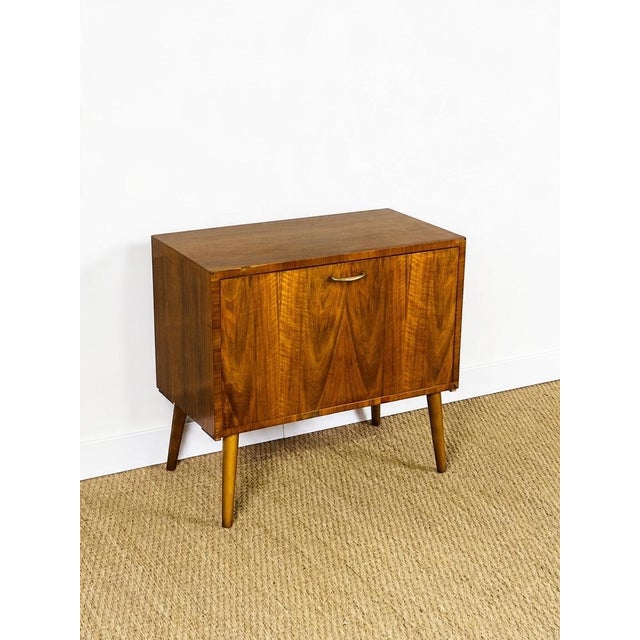 A charming little vintage secretary desk with an elegant and timeless design, typical of 1960s furniture. Its walnut...