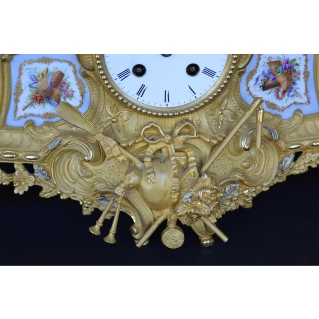 Cast metal clock depicting a pastoral farm scene and having eight-day movement, striking a bell on the hours and half...