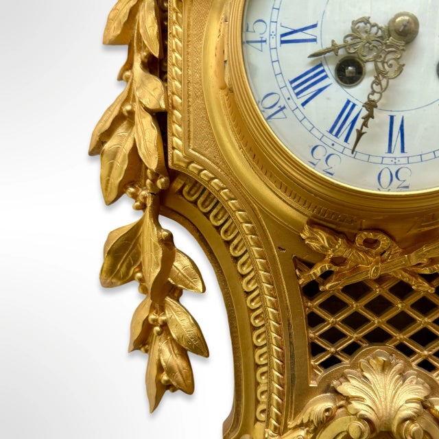 A premier antique French Rococo style gilt bronze Cartel clock by Japy Freres featuring enamel dial with blue Roman...