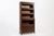 This tall antique English mission style five-stack wooden lawyer or barrister bookcase cabinet is from the early 1900s....