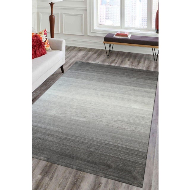 Fiona Ava Brown Handmade Wool Rug, Country of Origin: India. This stunning piece is a testament to the contemporary...