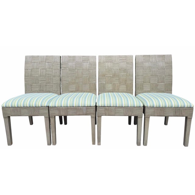 A set of four Braxton Culler dining chairs featuring painted wood frames with woven natural rattan backs and upholstered...