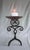 This Spanish Revival vintage candleholder is a well hand-crafted piece featuring wrought iron in an elaborate symmetrical...