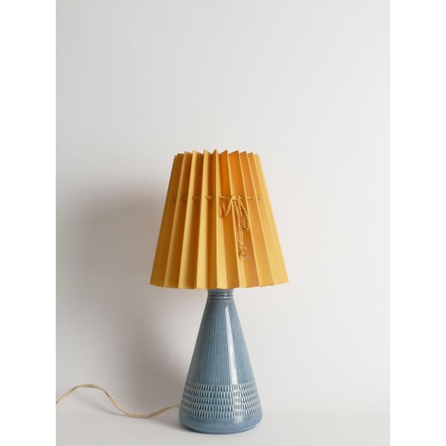 Mid-century–influenced swedish ceramic table lamp by rörstrand, dated 1986. This ceramic table lamp exemplifies...