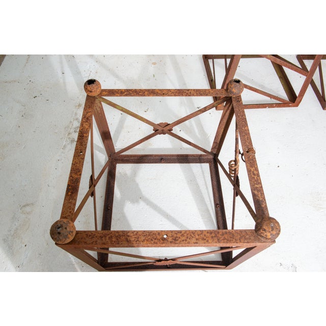 A pair of monumental rusted steel classical obelisks with ball finial tops, trellised sides, rosettes on cross members of...