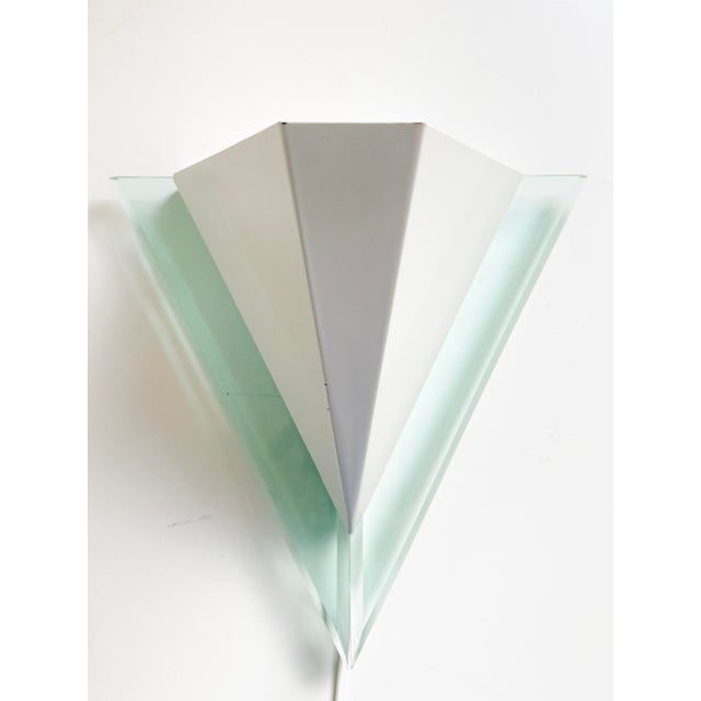 A vintage wall lamp / sconce by happy light, featuring a geometric postmodern design in white metal and pale green...