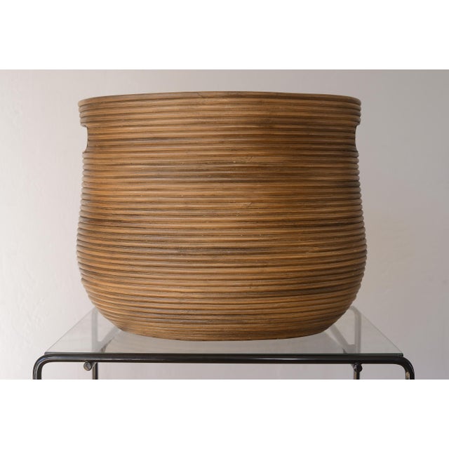 Unique vintage pencil reed basket in the style of Gabriella Crespi with cutout handles and faint S curve edges on the...