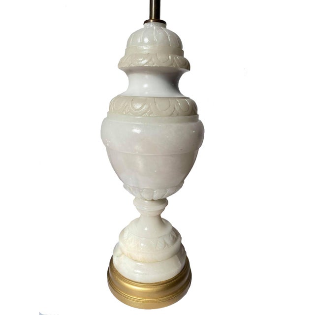 Beautifully carved alabaster table lamp with brass finial mounted on a gold wood base. Total Height 42" x Width 8" Total...