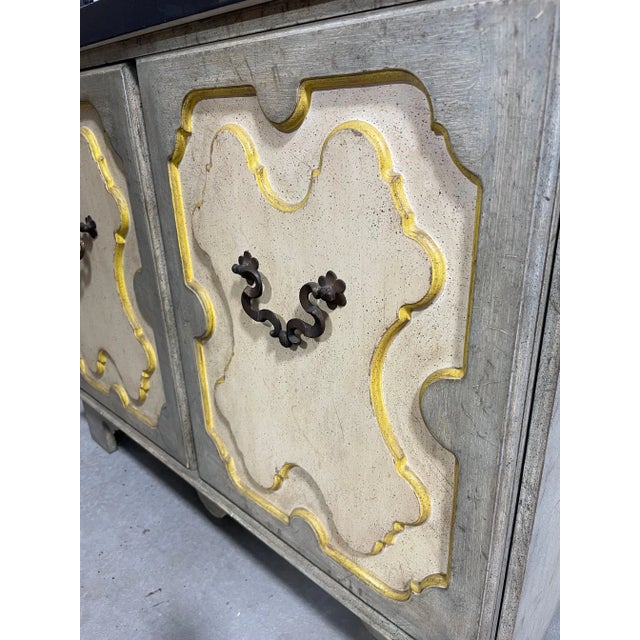 A polychromed door cabinet commode made by Baker Furniture Company; rendered in an unusual antiqued color palette of...