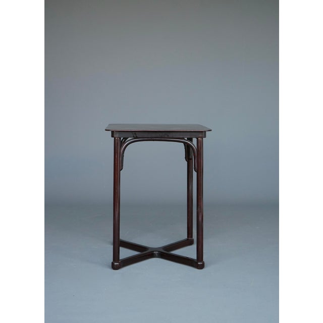 A small, elegant beech side or café table produced by the company of Jacob & Josef Kohn around 1910. This piece has an...