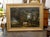 A large horizontal oil on canvas painting with gilded frame featuring men, horses and dogs painted in the style of Alvan...