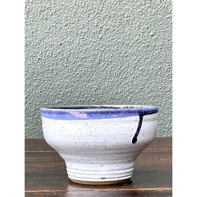 This vintage handcrafted blue and white stoneware bowl captures the enduring beauty of mid-century studio pottery through...