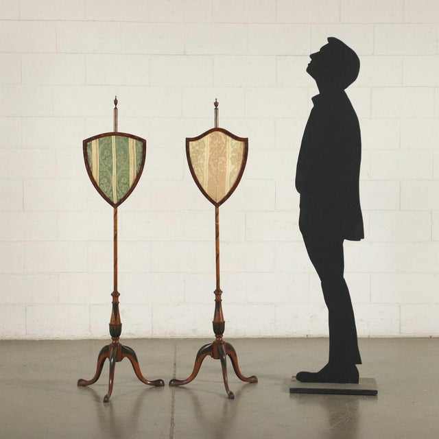 Two George IV screen poles, supported by 3 curved legs, on which stands a refined baluster engaged with the pole that ends...