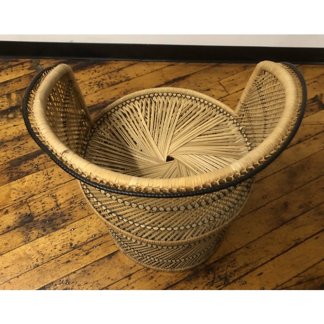 1960s Chic vintage natural wicker and rattan peacock-style chair with round barrel back and full skirt bottom. Perfect for...