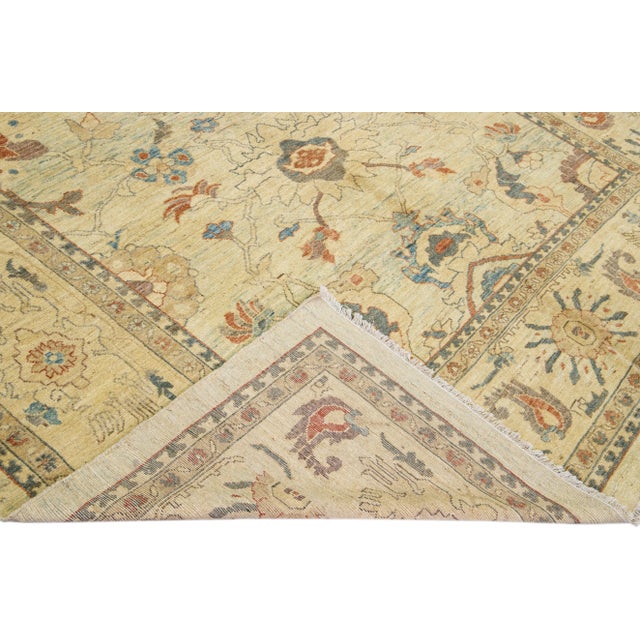 Beautiful modern Sultanabad hand-knotted wool rug with a beige field. This Sultanabad rug has brown, gray, and blue...