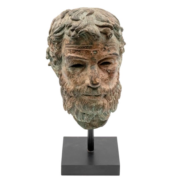 A striking Grand Tour-style bronze head fragment inspired by the sculptural traditions of ancient Greece and Rome....