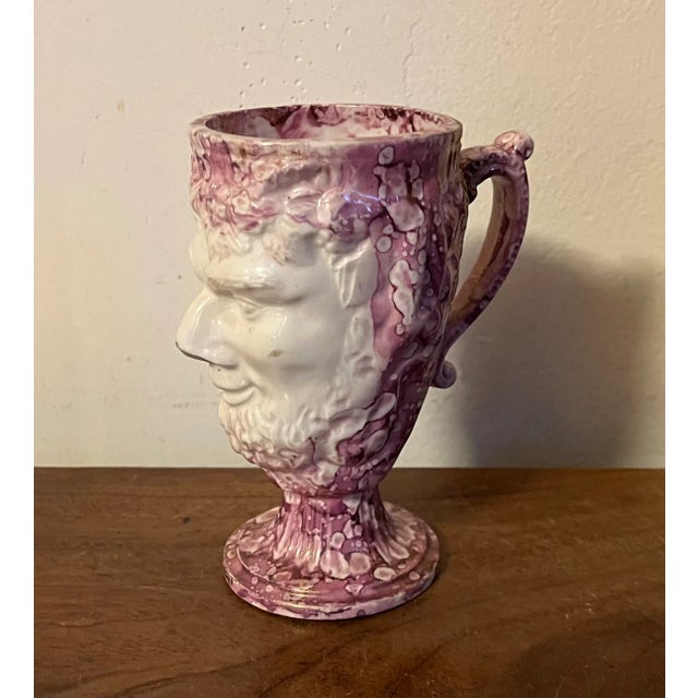 Antique 19th century English pink luster satyr head mug with leaping frog inside. Wonderful mottled surface. Measures 4...